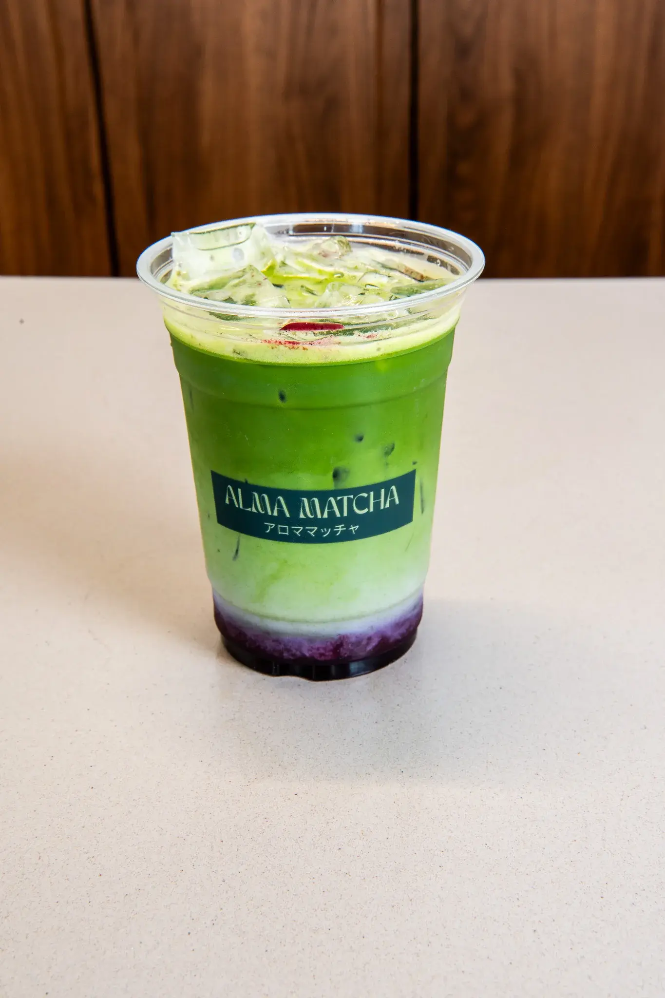 Signature iced matcha drink with Alma Matcha branding