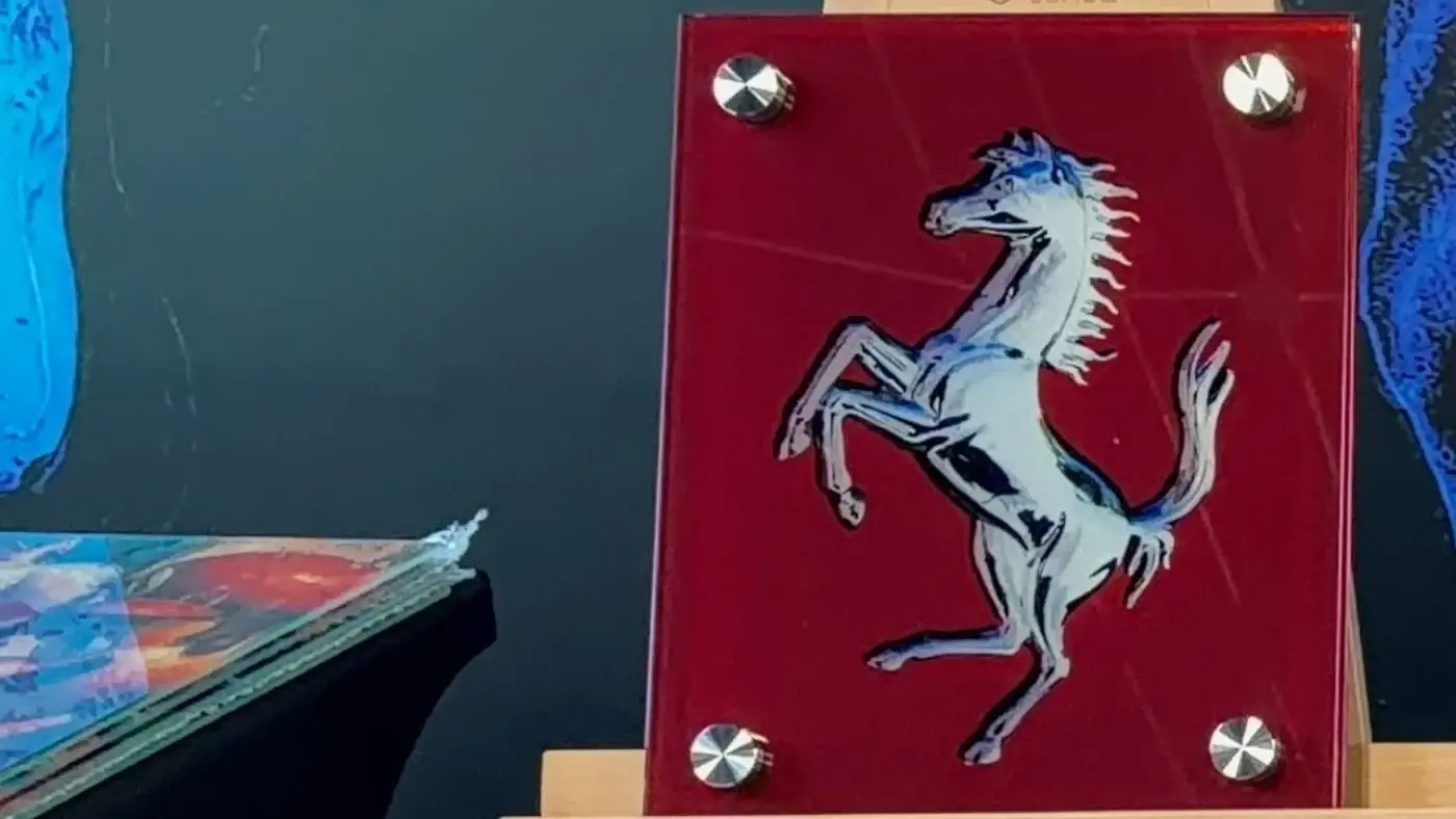 Ferrari prancing horse artwork on red glass by Dyer Design Glassworks